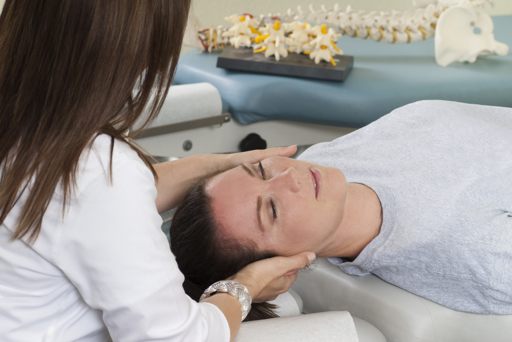 woman getting chiropractic adjustment in Dallas, TX